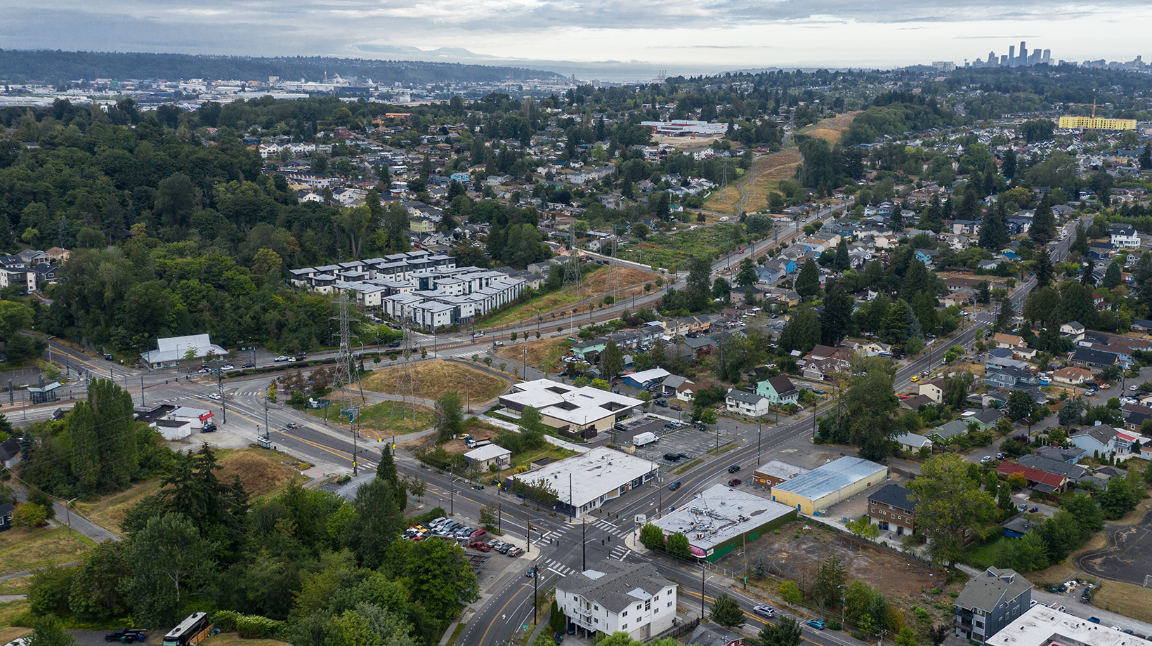 Aerial drone photo of Rainier Beach Clinic with Seattle skyline in the distance